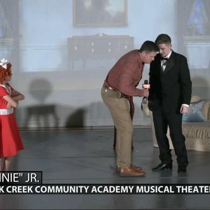 Keith Kaiser talks with actors and actresses in the production